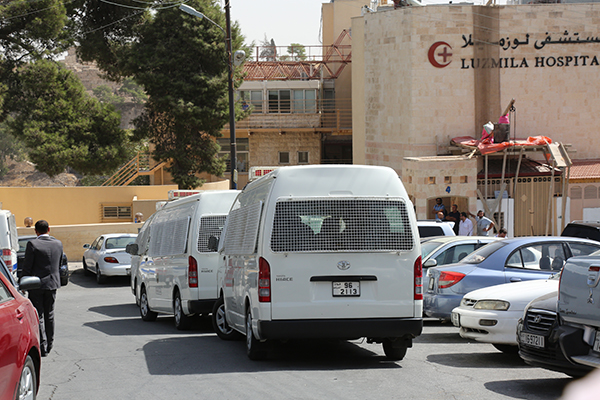 Police cars are seen outside Luzmila Hospital in Jabal Leweibdeh in Amman where Nahed Hattar was taken after being shot on Sunday (Photo by Raad Adaileh)